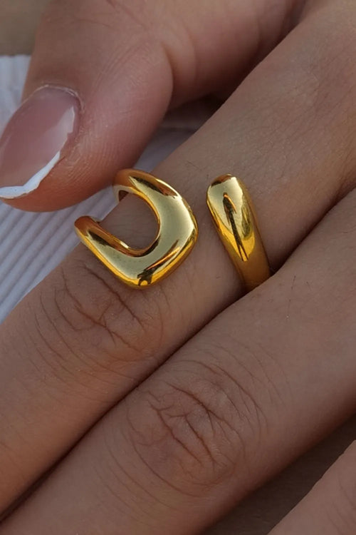 "Open gold ring worn on finger – stylish and minimal everyday jewelry with a bold artistic touch"